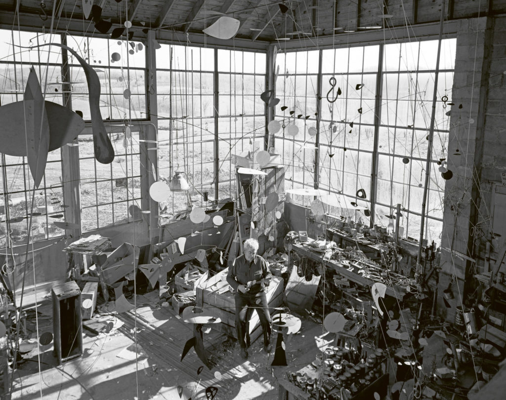 circa 1955:  American sculptor Alexander Calder of Roxbury uses sheets of tin, steel and lengths of wire for his mobile sculptures.  (Photo by Evans/Three Lions/Getty Images)