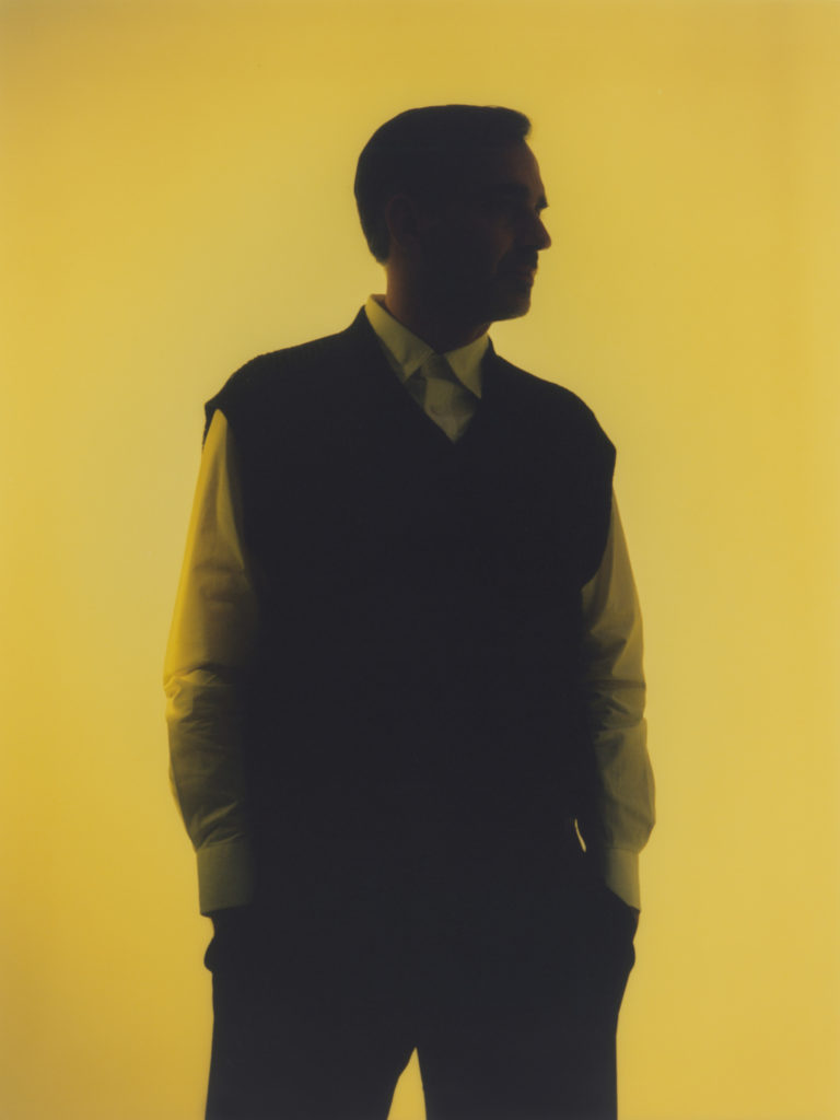 Erritzoe wears a shirt by CRAIG GREEN, a vest by COS and trousers and shoes by MARGARET HOWELL.