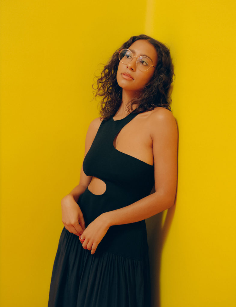 Makeup: Rebecca Alexander. Hair: Ben Skervin. She wears a dress by STELLA MCCARTNEY and jewelry by ANH JEWELRY.
