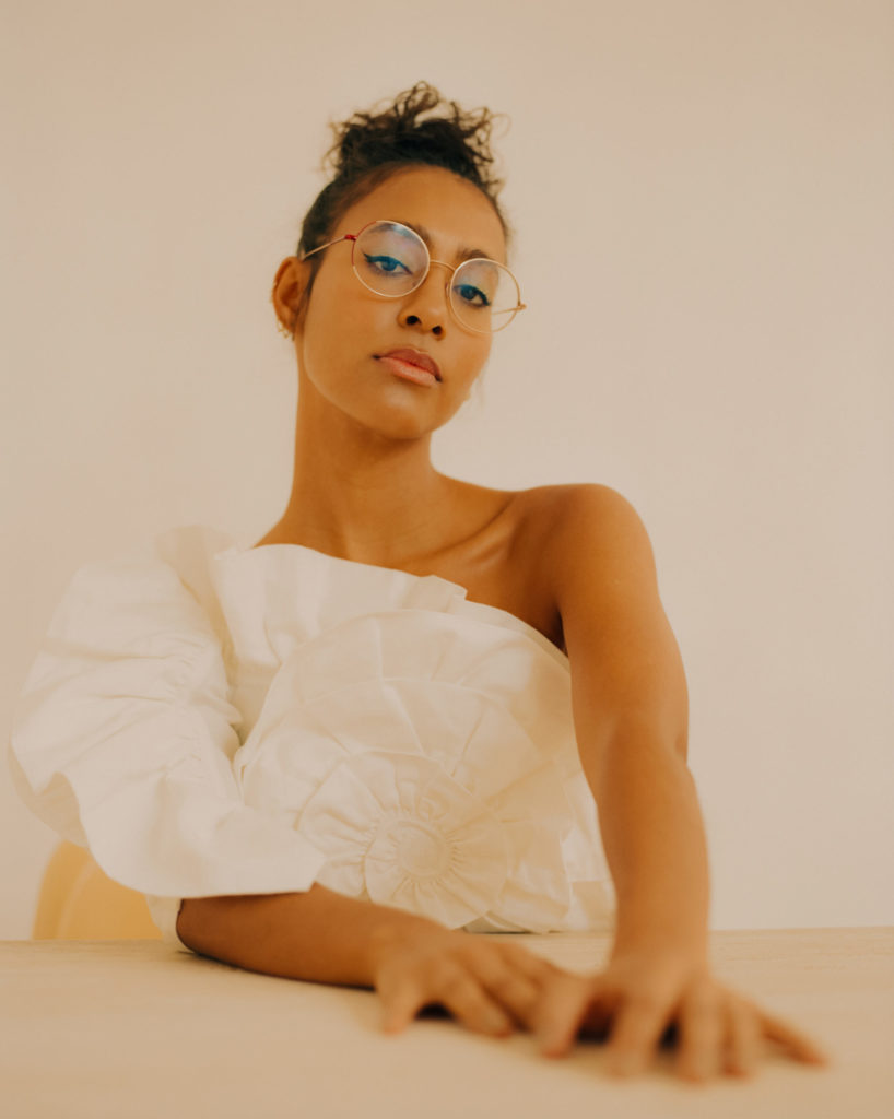 She wears a top by MARA HOFFMAN.