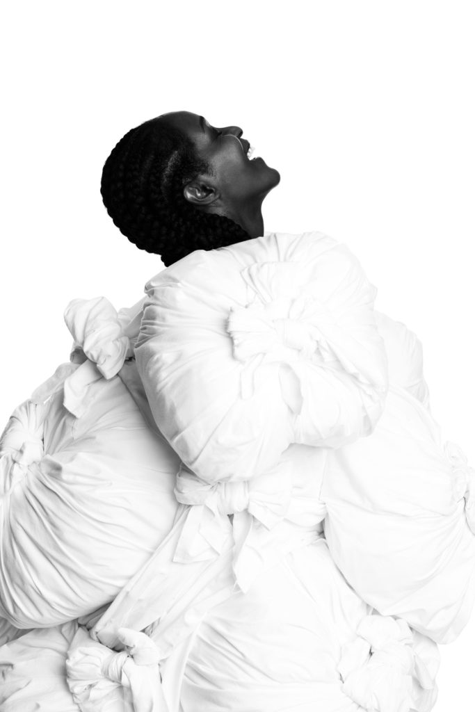 wears a dress by COMME DES GARÇONS (SS13).