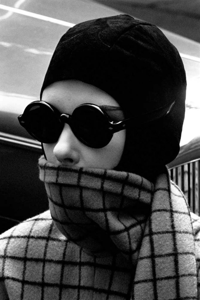 Close-up of American model and actress Peggy Moffitt (born Margaret Anne Moffitt) in a checkered sweater, black cap, and a pair of sunglasses, New York, New York, June, 24,1964. (Photo by Jerry Schatzberg/Getty Images)