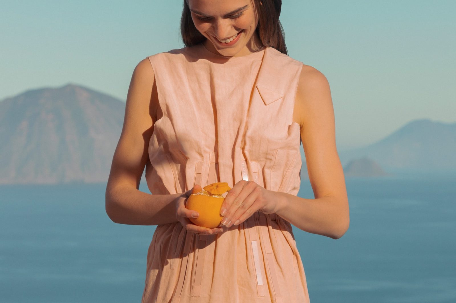 She wears a dress by PRADA.