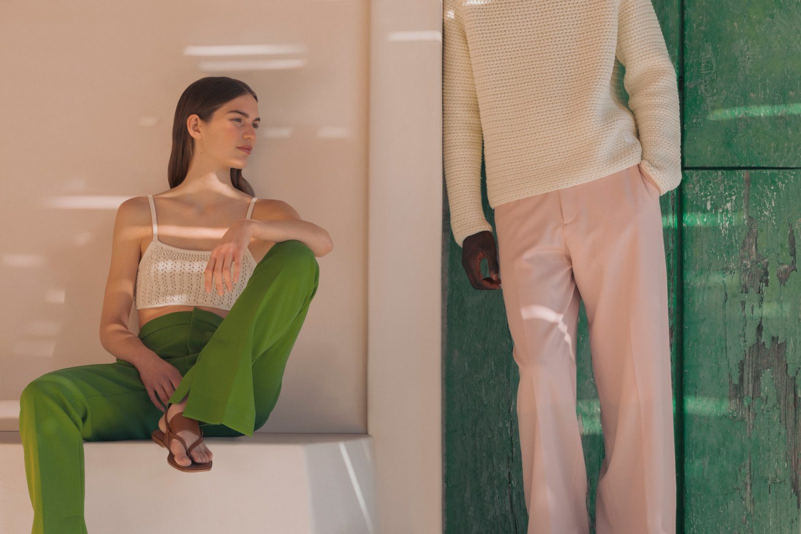 Anna wears a top by ARKET, trousers by GAUCHÈRE and sandals by LORO PIANA. Saliou wears an outfit by DIOR HOMME.